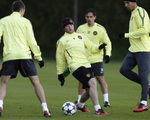 Manchester United's Wayne Rooney, centre left, trains with teammates at Carrington training...