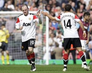 Manchester United's Wayne Rooney, left, reacts to his second goal against West Ham United with...