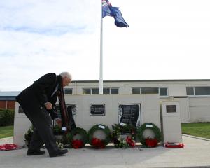 Maniototo RSA president Colin Smith lays a poppy on the Ranfurly War Memorial at Ranfurly on...