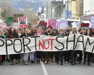 Marchers walk down George St on Saturday during the Dunedin Rape Crisis "Slutwalk" rally against...