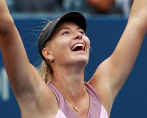 Maria Sharapova of Russia celebrates after defeating Marion Bartoli of France during their women...