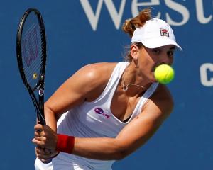 Marina Erakovic of New Zealand hits a return ball to Petra Kvitova of the Czech Republic at the...