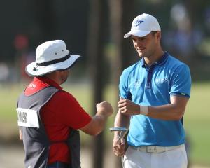 Martin Kaymer (right) celebrates with caddie Craig Connolly after making a putt on the 17th hole....