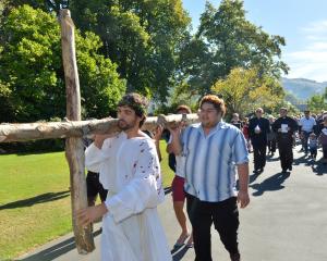 Max Whitaker leads the North Dunedin Walk of the Cross through the Dunedin Botanic Garden...