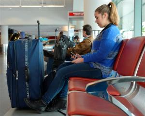 Melissa Giddens (18) waits for her flight out of Dunedin to Wellington after a raft of flights...