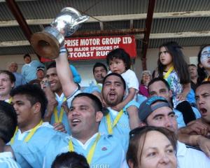 Members of the East Coast rugby team celebrate after winning the Meads Cup final between East...