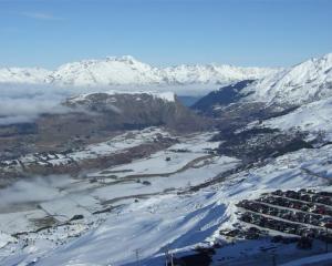 Mist over the Wakatipu Basin begins to lift, looking from Coronet Peak towards Queenstown. Photo...