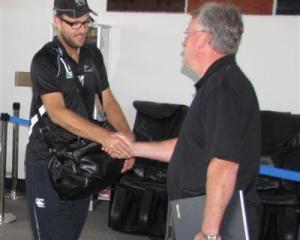 New Zealand captain Daniel Vettori  is greeted by Queenstown liaison manager Ian Paterson as the...