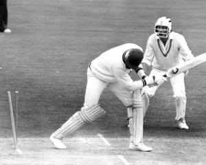 New Zealand fielder Stephen Boock looks on as West Indian batsman Joe Garner is bowled by Richard...