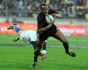 New Zealand's Joe Rokocoko slips a diving French tackle at Westpac Stadium. Credit:NZPA / Ross...
