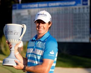 Northern Ireland golfer Rory McIlroy holds up the championship cup after winning the Deutsche...