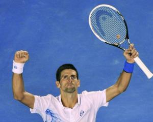 Novak Djokovic of Serbia celebrates after defeating David Ferrer of Spain in their quarterfinal...
