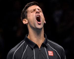 Novak Djokovic reacts after breaking Rafael Nadal's serve. REUTERS/Toby Melville