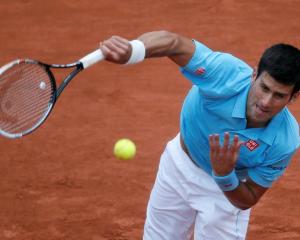 Novak Djokovic serves to Joao Sousa. REUTERS/Gonzalo Fuentes