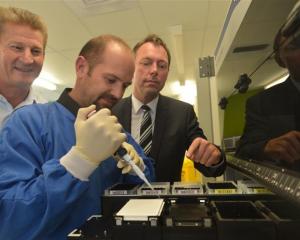 On task are (from left) Pacific Edge chief executive David Darling, senior scientist Justin...