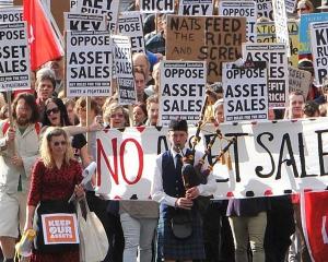Opponents of state asset sales march down George St on Saturday before a rally in the Octagon....
