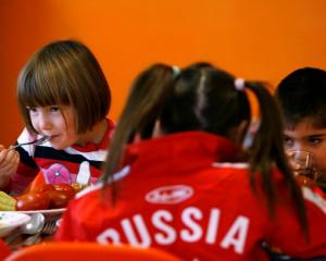 Orphan children have a meal at an orphanage in the southern Russian city of Rostov-on-Don....