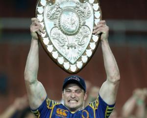 Otago captain Paul Grant holds the Ranfurly Shield aloft after his team beat Waikato in Hamilton...