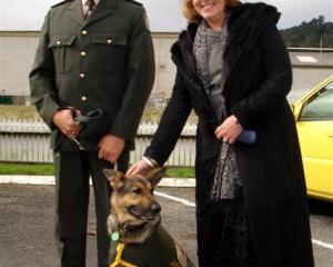Otago Corrections Facility dog handler Werner Botha and Corrections Minister Judith Collins with...