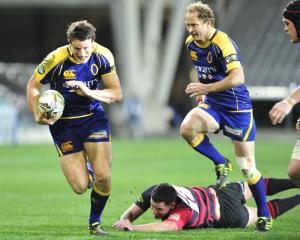 Otago fullback Glenn Dickson (left) goes on the charge against Canterbury at Forsyth Barr Stadium...