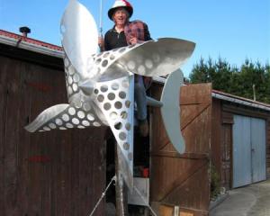 Going for a spin . . . Wind power enthusiast John McCabe shows his new wind turbine sculpture,...