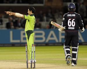 Pakistan's Umar Gul (left) celebrates after claiming the wicket of England's Graeme Swann during...