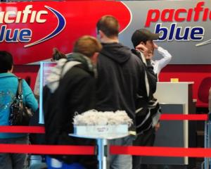 Passengers line up to check in for a flight to Auckland yesterday at Dunedin International...