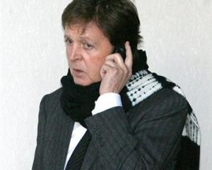 Paul McCartney is shown using his mobile phone in this file photo.(AP Photo/Dominic Lipinski/PA,...
