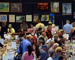 People hunt for anything but books on the Regent Theatre stage at the Anything But Books Sale...