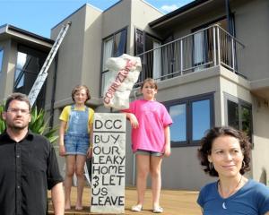 Pictured in February 2011 outside their leaky home in Glenleith are (from left) Michael Beazley,...