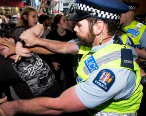 Police and security clash with protesters outside SkyCity during the post-Budget address. Photo...