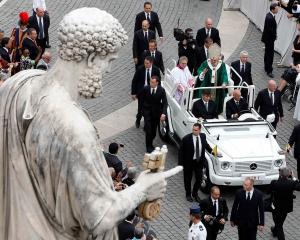 Pope Benedict XVI waves as he leaves at the end of a mass marking the opening of the Synod of...