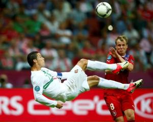 Portugal's Cristiano Ronaldo kicks the ball in front of Czech Republic's Michal Kadlec (R) during...