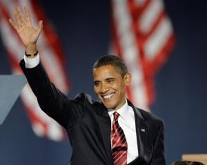 President-elect Barack Obama waves as he takes the stage at his election night party in Chicago's...