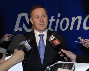 Prime Minister Rt Hon John Key answers questions from media after talking at the National Party...