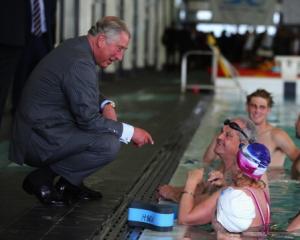 Prince Charles chats with swimmers at the Millenium Sports Institute. (Photo by Phil Walter/Getty...