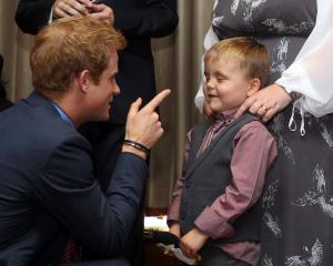 Prince Harry talks to 6-year-old Alex Logan as he attends the WellChild awards ceremony at the...