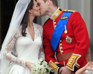 Prince William kisses his wife Kate, Duchess of Cambridge on the balcony of Buckingham Palace. ...