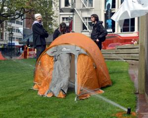 Protesters (from left) Luke Benton, Peter Gutteridge, and Anton Styles re-occupy the Octagon...