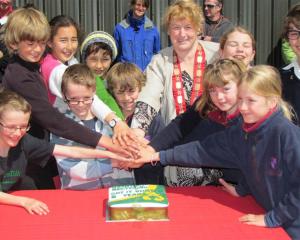 Queenstown Lakes  Mayor Vanessa van Uden and local schoolchildren cut a cake celebrating five...