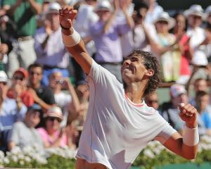 Rafael Nadal of Spain celebrates defeating Novak Djokovic of Serbia in their men's singles semi...