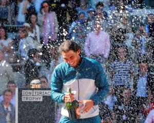 Rafael Nadal of Spain sprays champagne after winning the Madrid Open final against Stanislas...