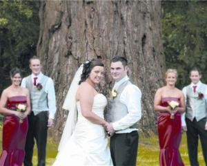 Rebecca Knight and Regan Brown with their wedding party at Mount Stuart Reserve, after their...