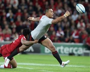 Robbie Fruean of the Crusaders, right, is tackled by Ben Tapuai of the Reds. (AP Photo/Tertius...