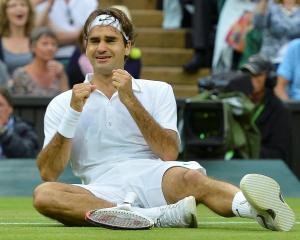 Roger Federer of Switzerland celebrates after defeating Andy Murray of Britain in their men's...