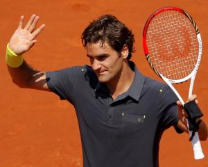 Roger Federer of Switzerland waves after winning his match against Tobias Kamke of Germany at the...