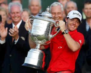 Rory McIlroy of Northern Ireland lifts the Wanamaker Trophy after capturing PGA Championship at...