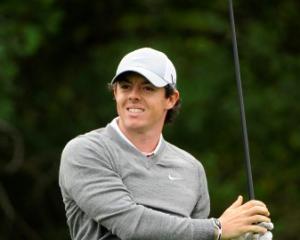Rory McIlroy watches the path of his tee shot on the 3rd hole during the first round in the Honda...