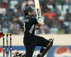 Ross Taylor watches a ball he hit go for six during the Cricket World Cup quarterfinal between...