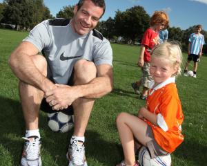 Ryan Nelsen with 4-year-old Lucy Vink at the Cashmere Wanderers Soccer Club in Christchurch...